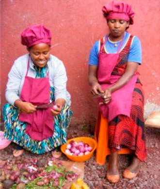 Marefya [left] proudly prepares a meal for the restaurant she helps manage
